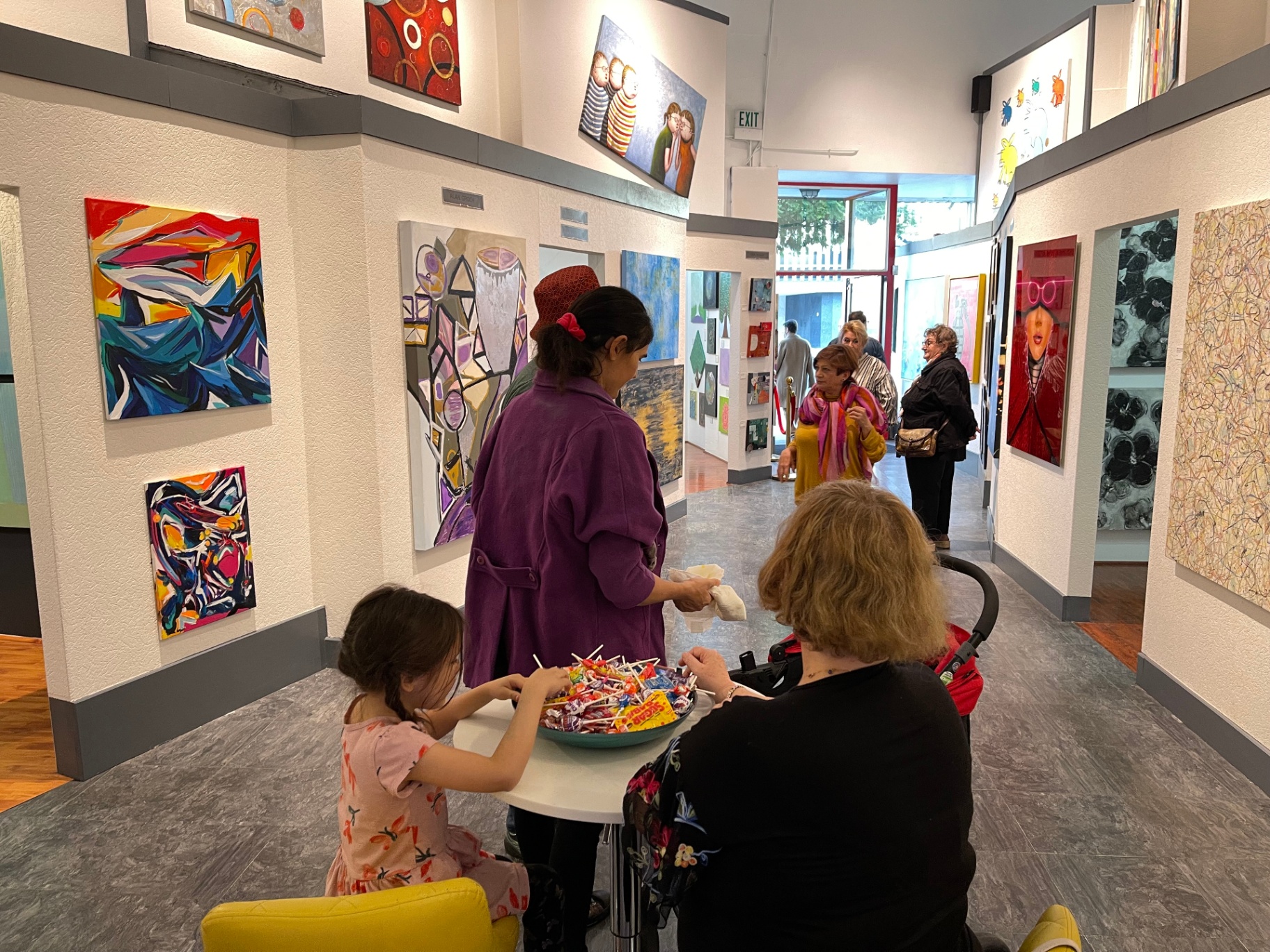 Visitors browsing the colorful gallery hallway of the LA District.
